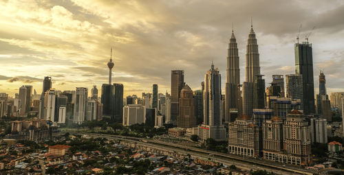 View of skyscrapers against cloudy sky