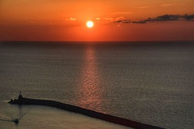 Scenic view of sea against romantic sky at sunset