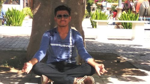 Portrait of smiling mid adult man sitting outdoors