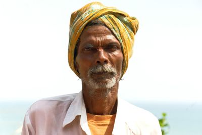 Close-up portrait of man wearing mask against white background