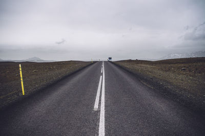 Empty road amidst field