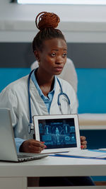 Businesswoman using laptop at office