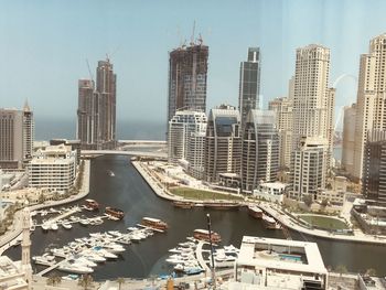 Aerial view of modern buildings in city against sky