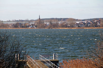 Boats in river with buildings in background