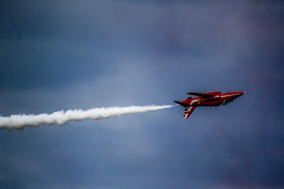 Low angle view of airplane flying against sky