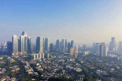 Modern buildings in city against clear sky