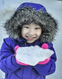 Portrait of young girl holding ice