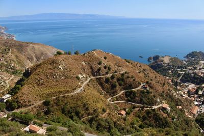 High angle view of sea and mountains against sky