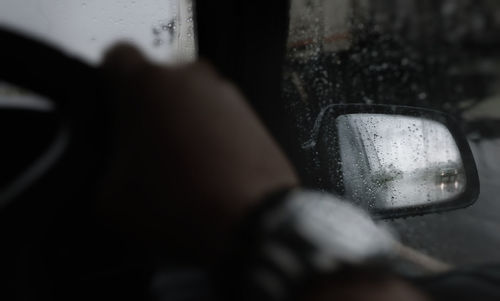 Close-up of hand holding glass of car