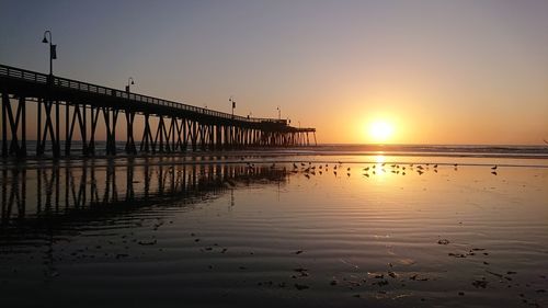 Scenic view of sea against orange sky