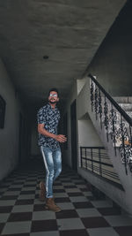 Portrait of man standing on staircase