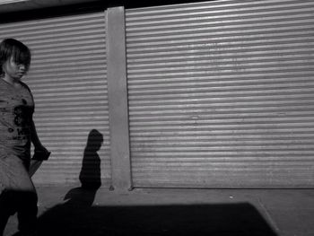 Rear view of boy walking on floor