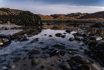 Rocks on shore against sky