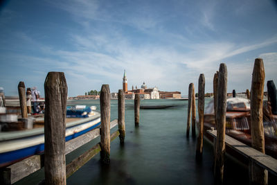 Panoramic shot of wooden post in sea against sky in venice, italy 