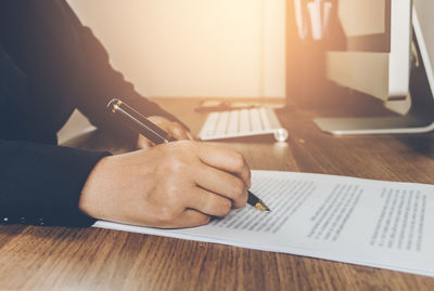 Midsection of man working on table