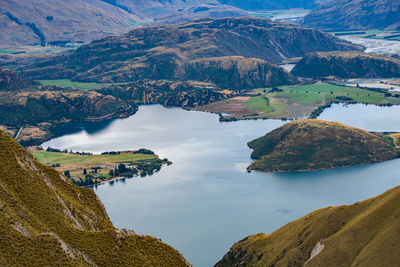 High angle view of lake and mountains against sky