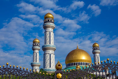 Low angle view of bell tower against blue sky