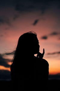 Portrait of silhouette woman against sky during sunset