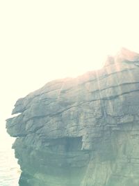 Close-up of cliff against clear sky