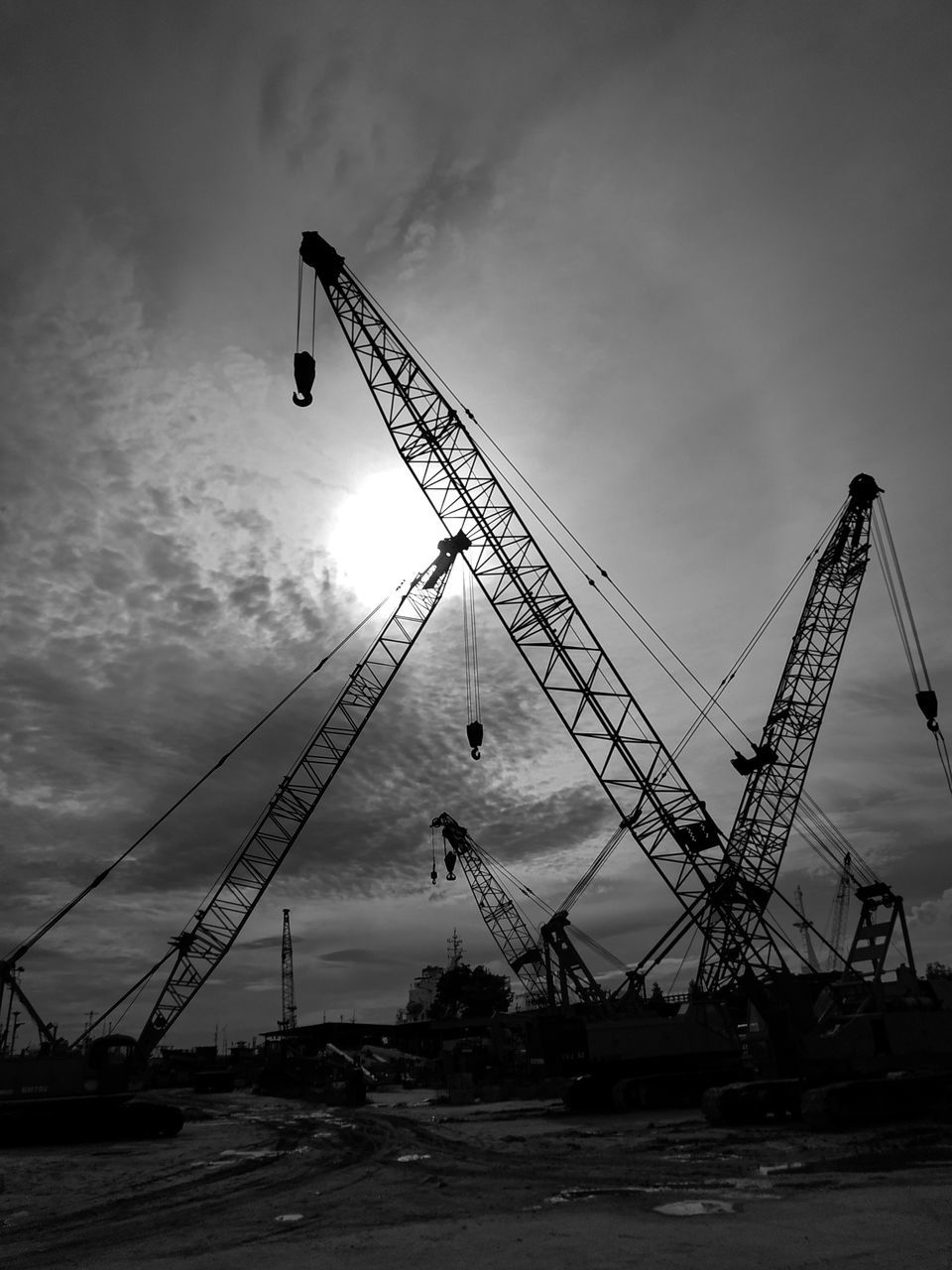 CRANE AT CONSTRUCTION SITE AGAINST SKY