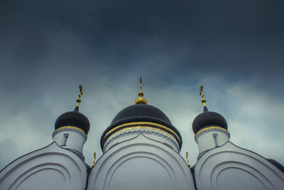 Low angle view of trinity cathedral against cloudy sky at zadonsk