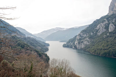 Scenic view of river amidst mountains against sky