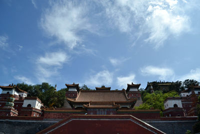 Buildings in town against sky