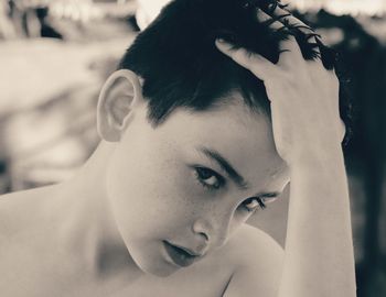 Close-up portrait of shirtless young man