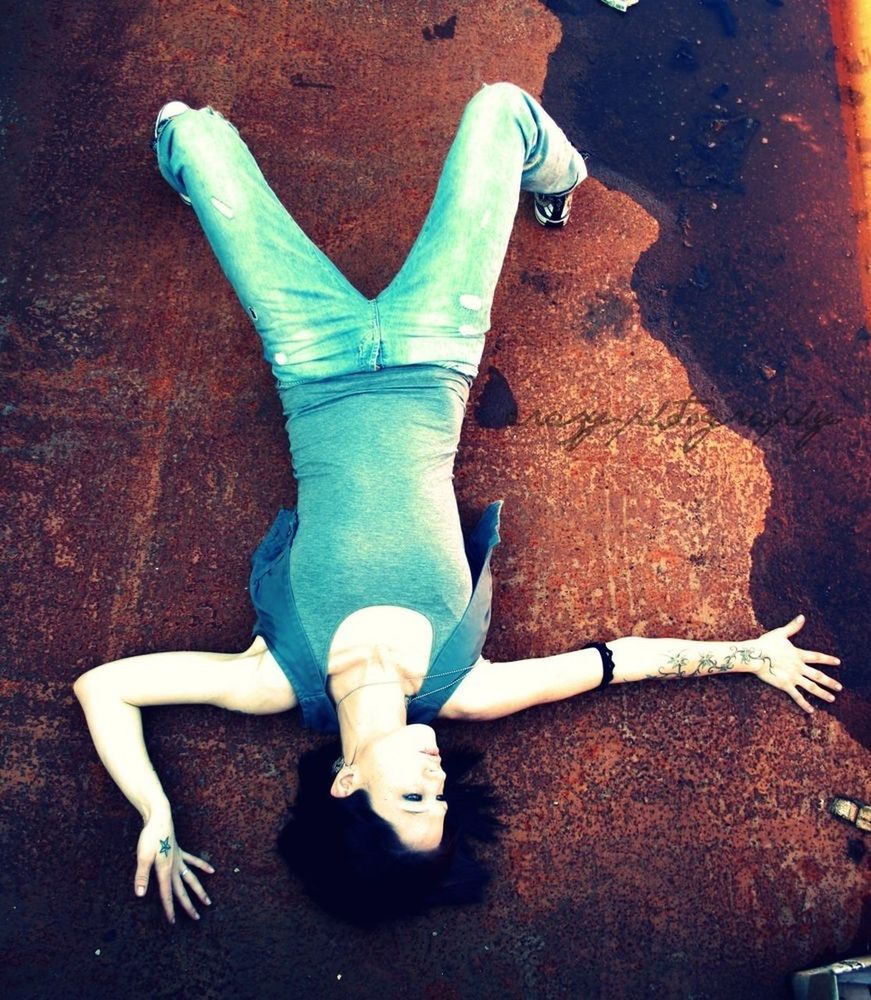 HIGH ANGLE VIEW OF WOMAN LYING DOWN ON TILED FLOOR