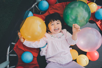 High angle view of woman with balloons