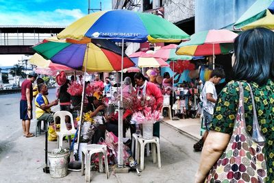 People on multi colored umbrellas against sky