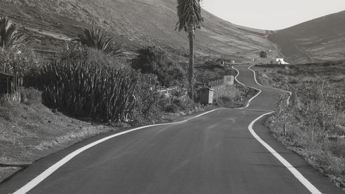 Empty road along landscape and mountains