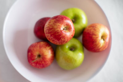 High angle view of apples in plate on table