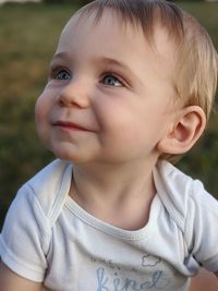 Close-up portrait of cute boy looking away