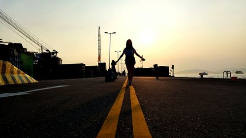 Rear view of man standing on road