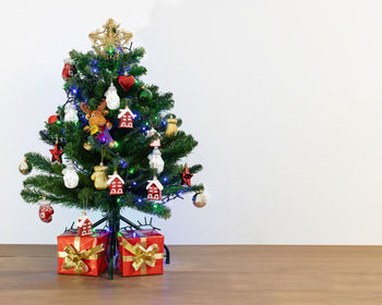 Christmas tree on floor against wall