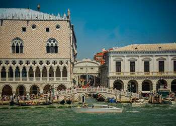 View of boats in canal against buildings