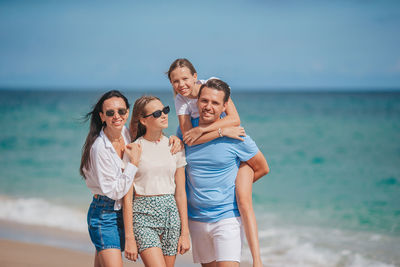 Friends standing at beach