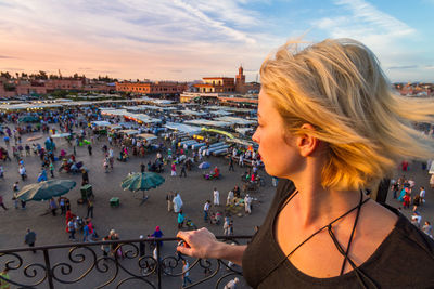 Portrait of woman with cityscape in background