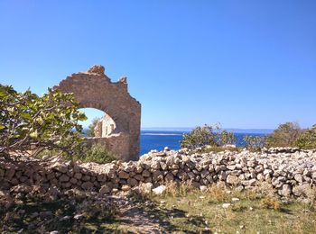 Scenic view of sea against clear blue sky