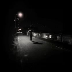 Blurred motion of people walking on road at night