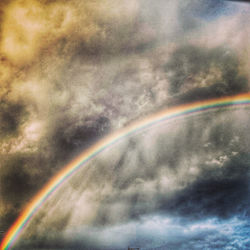 Low angle view of rainbow in sky