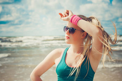 Young woman wearing sunglasses on beach