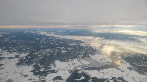 Aerial view of snowcapped landscape against sky