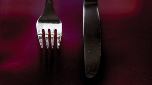 Close-up of glass container on table against black background