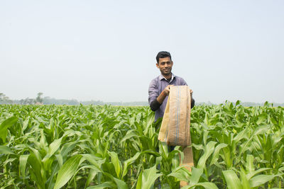 Portrait of man standing in field