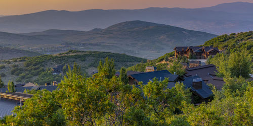 Scenic view of mountains and houses against sky