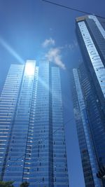 Low angle view of modern building against blue sky