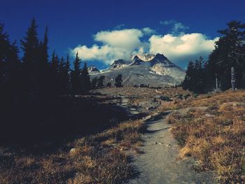 Scenic view of landscape against cloudy sky