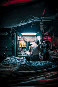 People working at market stall